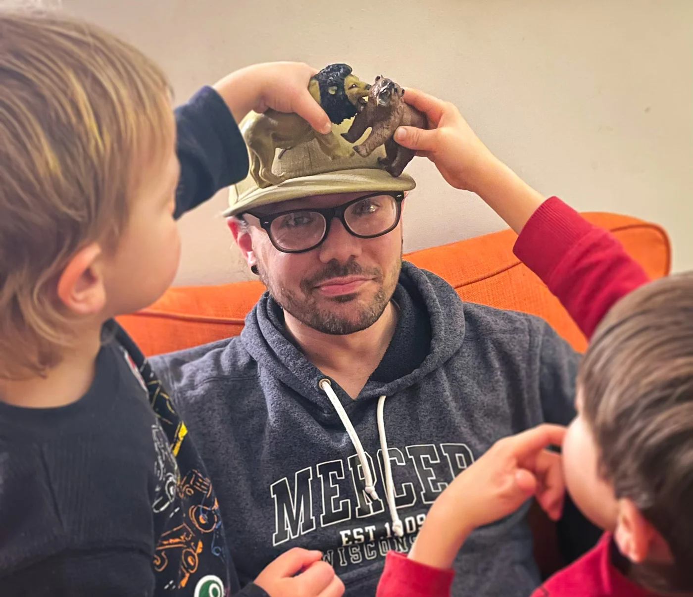The app creator playing with animal toys with two of his kids